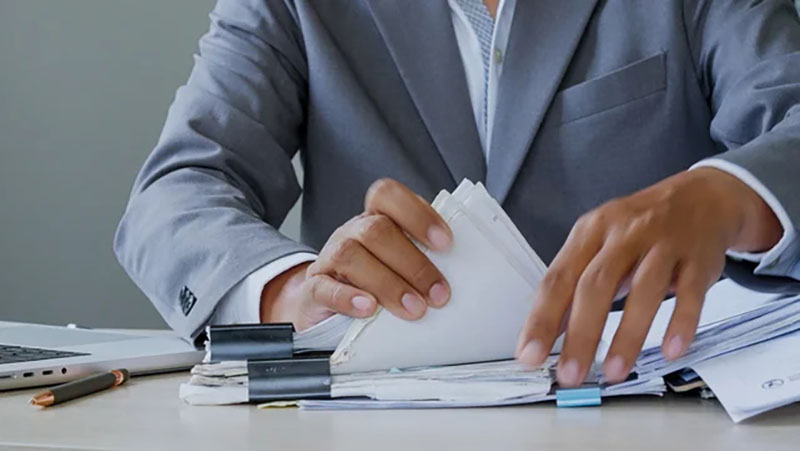 businessman sorting through paperwork